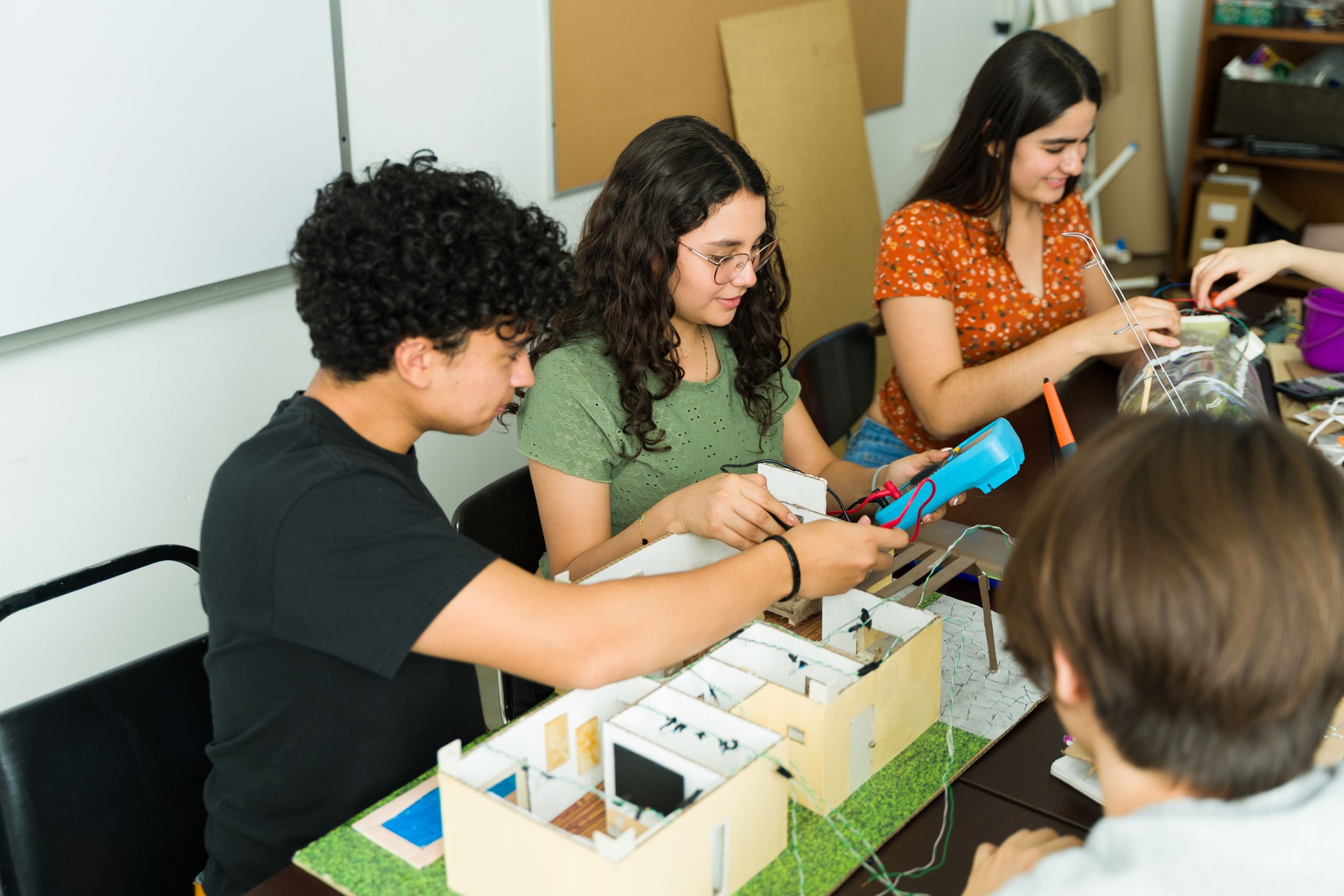High school students working on electronics project for stem class