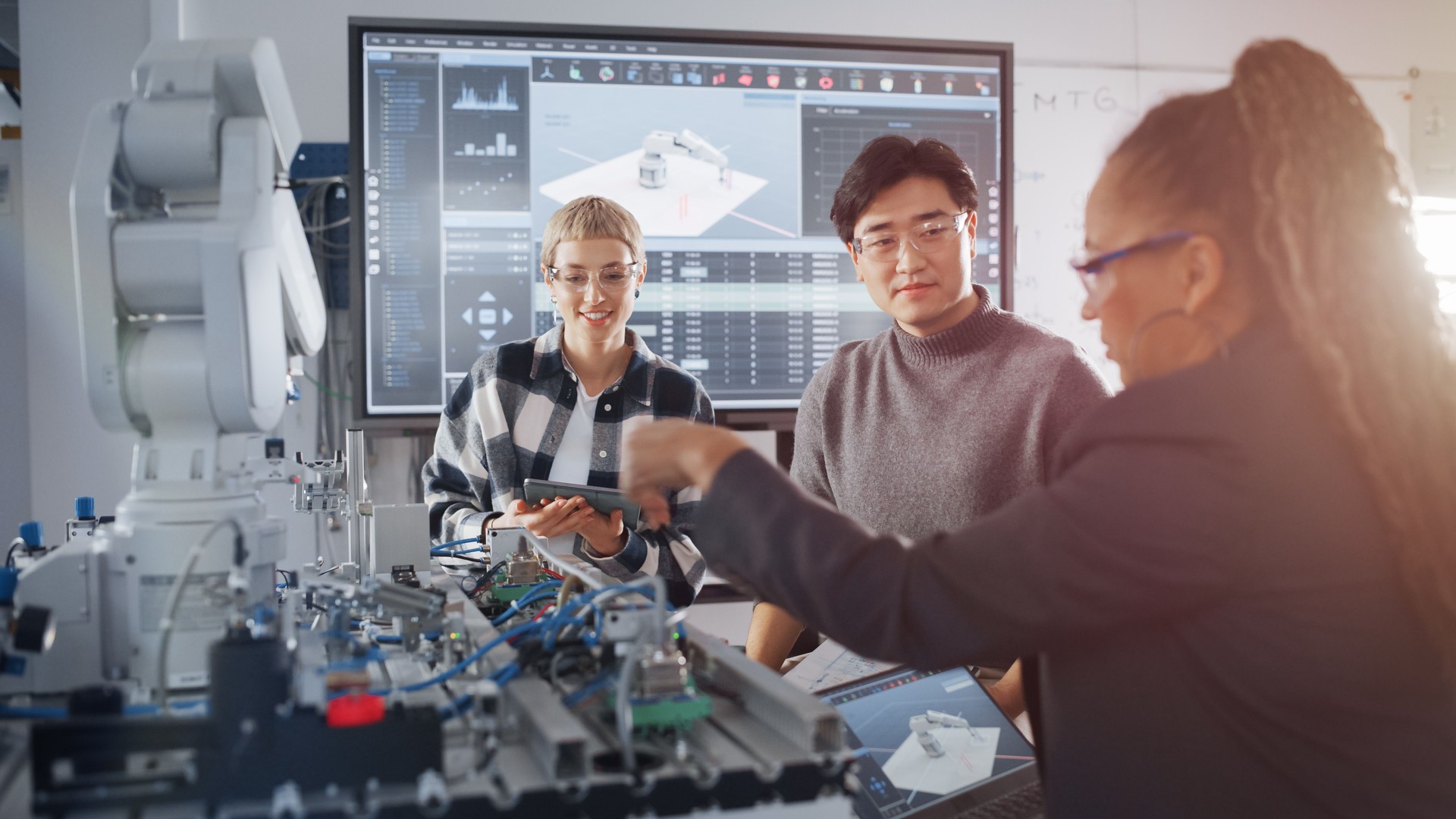 Curious Students Telling Ideas to Black Teacher while Working Together on Modification of Functions of Mechanical Arm for Engineering Project at School. Computer Science Education Concept.